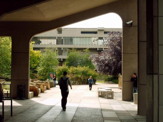Walking underneath the archway of the Roger Stevens Building